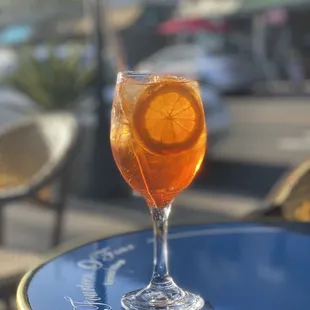 a glass of orange juice on a table