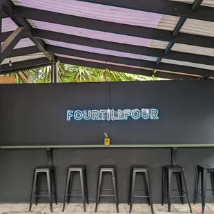 a bar with four stools