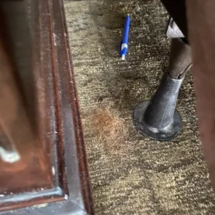 Hairball and stray pen found between nightstand and bed. (Not mine!) Front desk now knows that room 201 requires a deep clean.