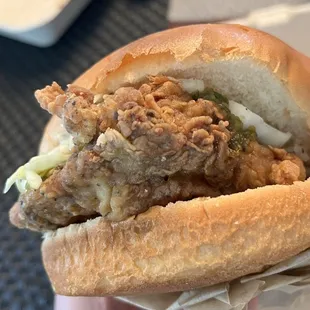 a hand holding a sandwich