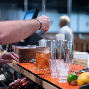 a bartender pouring a drink