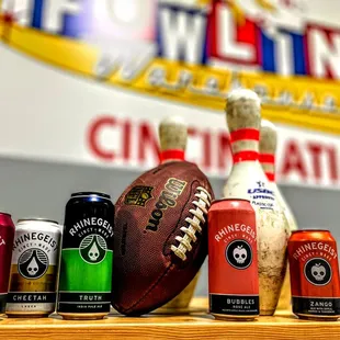 a variety of beer cans and a football
