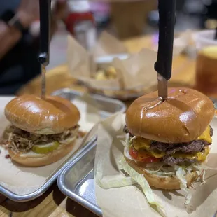 two burgers on trays