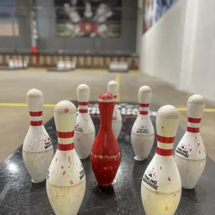 bowling pins with paint splattered on them