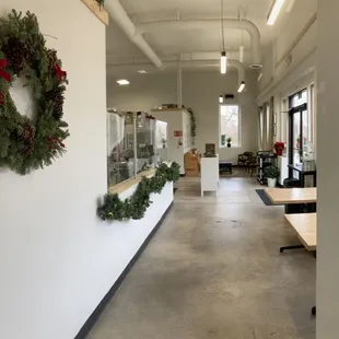 a long hallway with wreaths on the wall