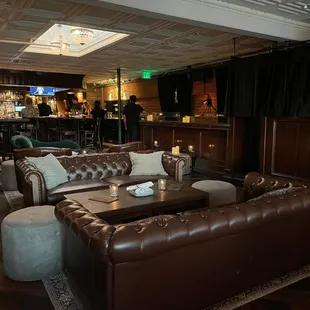 a living room with a bar in the background