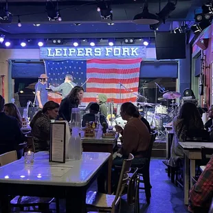 people sitting at tables in a restaurant