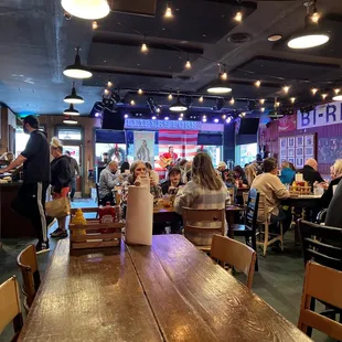 people sitting at tables in a restaurant