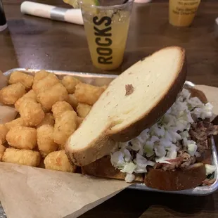 Pork sandwich (on Texas toast) with tator tots. Drink: pitchin good time