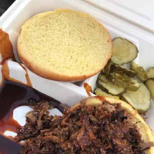 Chopped Brisket Sandwich with pickles and spicy BBQ sauce