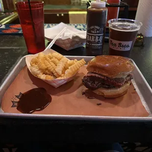 Brisket sandwich, fries, Shiner Bock beer.