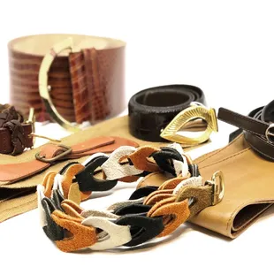 assortment of vintage belts, including designers Christian Dior, Calvin Klein, and Express.