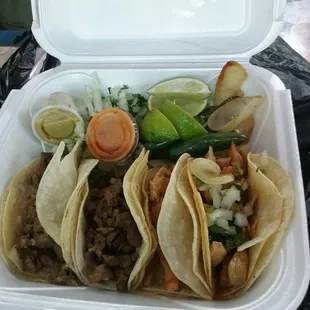 Two chicken and two beef tacos with all the fixings