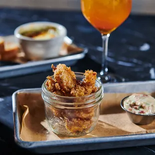 a tray of food and a glass of beer