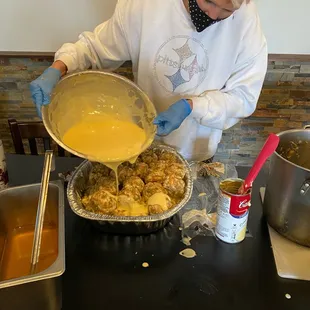 a woman in a kitchen preparing food