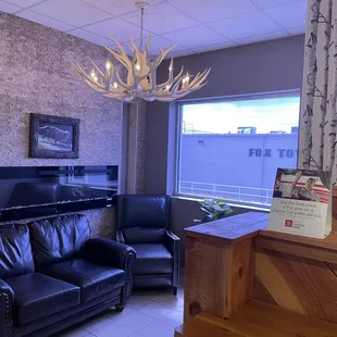 Additional service waiting area. Comfy leather furniture and cool fire place.