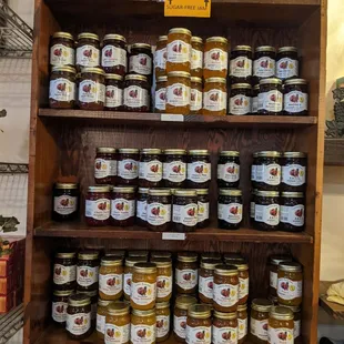 a shelf of jars of honey