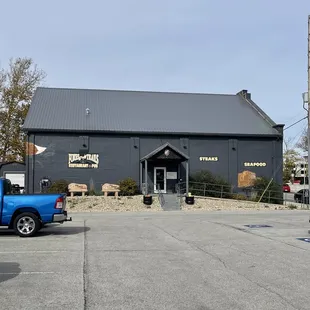 a blue truck parked in front of a building