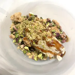 a plate of food with meat and nuts