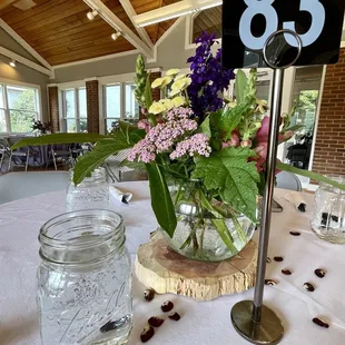 a table setting with flowers and jars