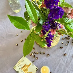 a table with flowers and candles