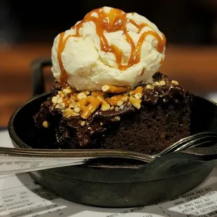 a chocolate cake with ice cream and caramel
