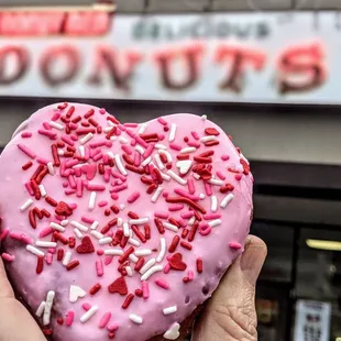 Valentine&apos;s pink iced with sprinkles heart donut!