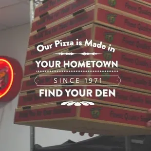 a man holding a box of pizza