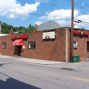 a brick building with a red awning