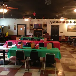 tables and chairs with green tablecloths