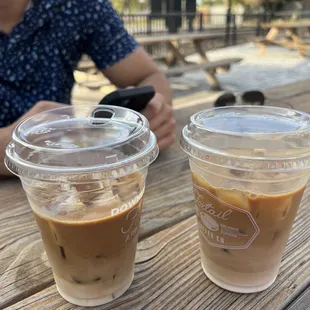 two cups of coffee on a picnic table