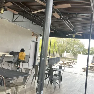 Outdoor patio with picnic tables in back