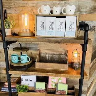 a shelf with coffee, teapots, and other items