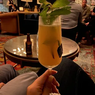 a person holding a cocktail