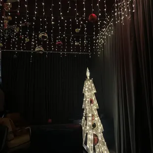a lighted christmas tree in a dark room