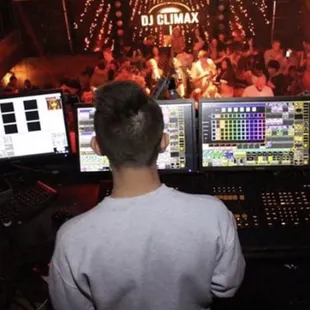 a dj in front of two monitors