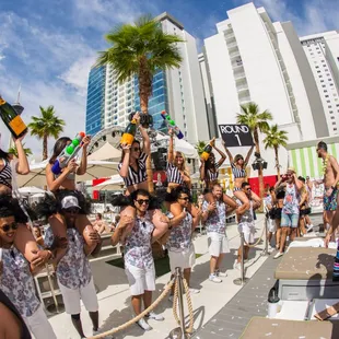 a group of people dancing in the pool