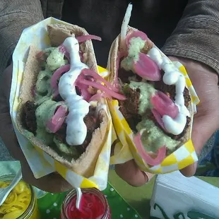 a person holding a sandwich
