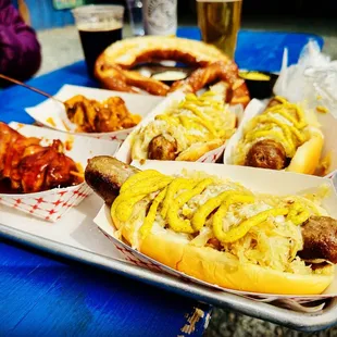 a tray of hot dogs with mustard and ketchup
