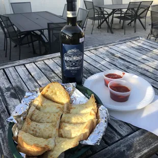 a bottle of wine and a plate of bread