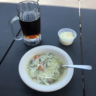 a bowl of soup and a glass of beer