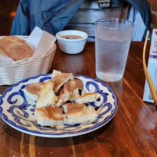 a plate of bread and a glass of water