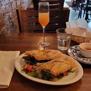 a plate of food and a glass of orange juice