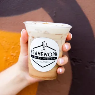 a hand holding a cup of coffee