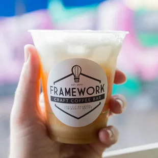 a hand holding a cup of coffee