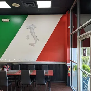 Front door at right with map of Italy and modified Italian flag painted on wall.