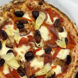 a pizza with olives and artichokes