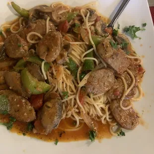 a plate of spaghetti with meat and vegetables