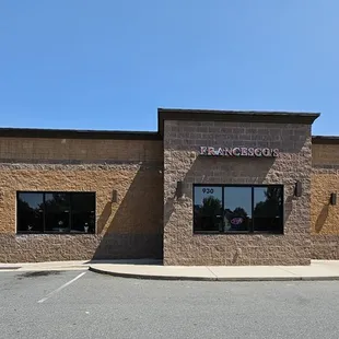 two cars parked in front of a restaurant