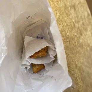 a pastry in a paper bag